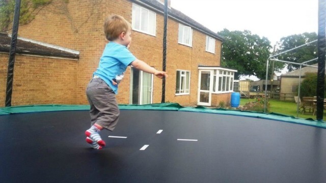 toddle bouncing on garden trampoline