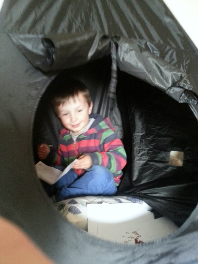 playing inside his Crayole crazy glow tent