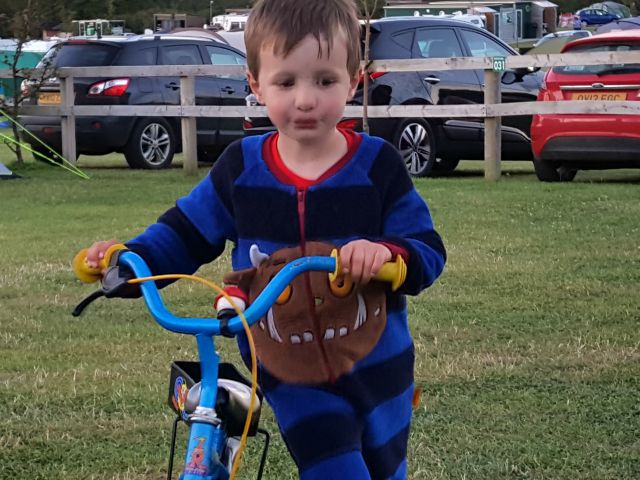 Hanging out in his Gruffalo onesie and bike