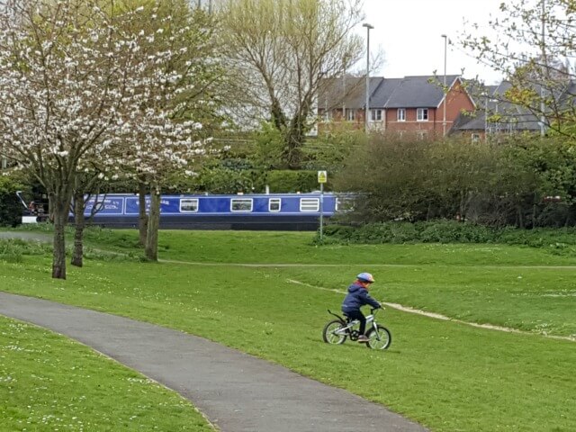 cycling downhill in spiceball park by Banbury canal