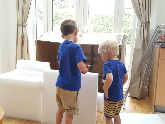 godbrothers playing with boxes