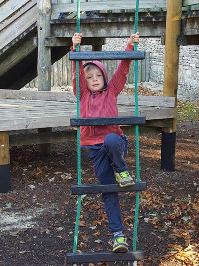 climbing a play rope ladder