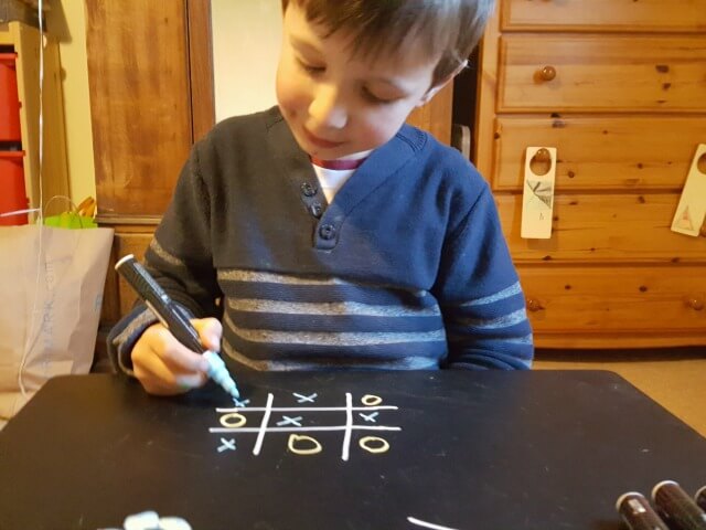 noughts and crosses on chalkboard