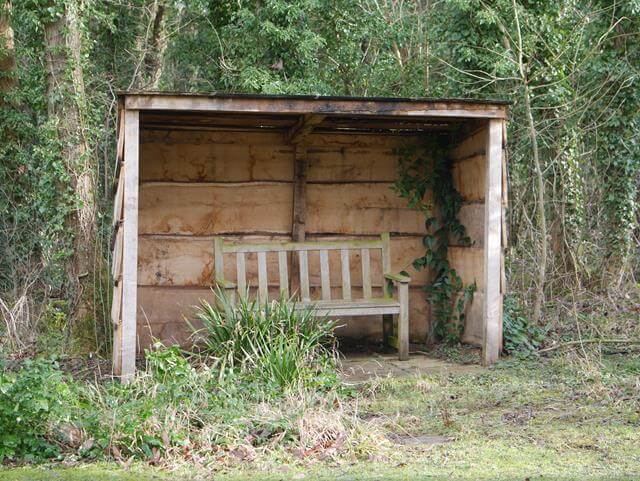 bench in a shelter at evenley wood garden