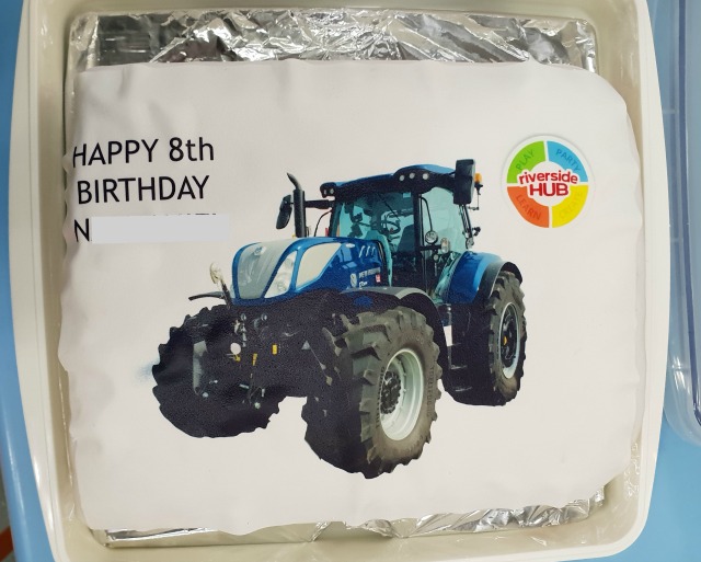 8th birthday cake with blue new holland tractor