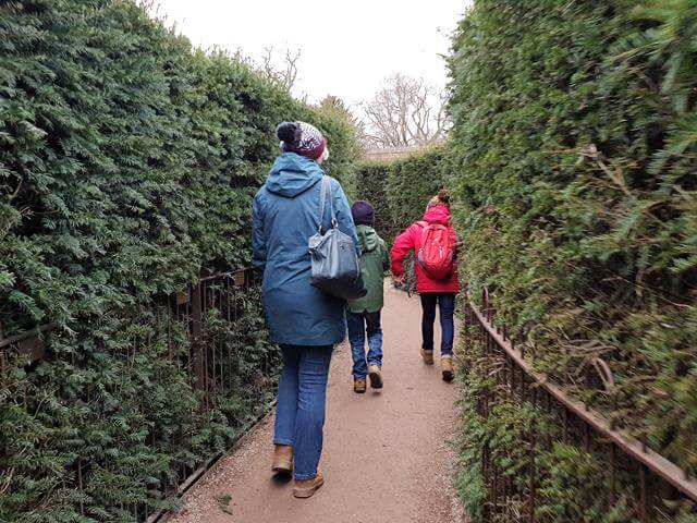 starting off going into the maze, 1 adult 2 children