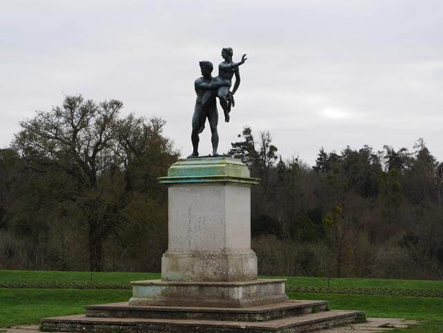 statue with 2 people sculpture on top