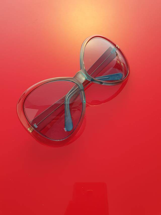 red sunglasses on red background