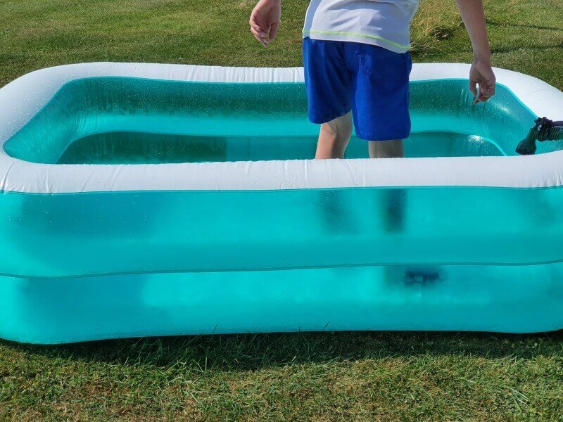 standing in the paddling pool