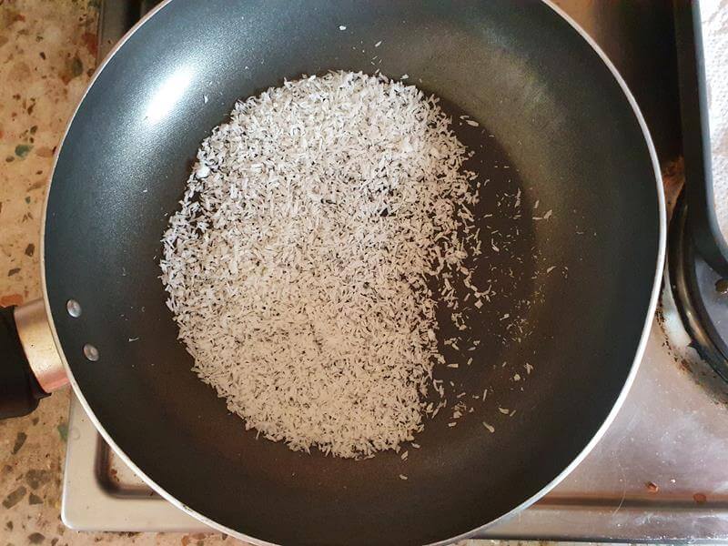 toasting coconut in a frying pan