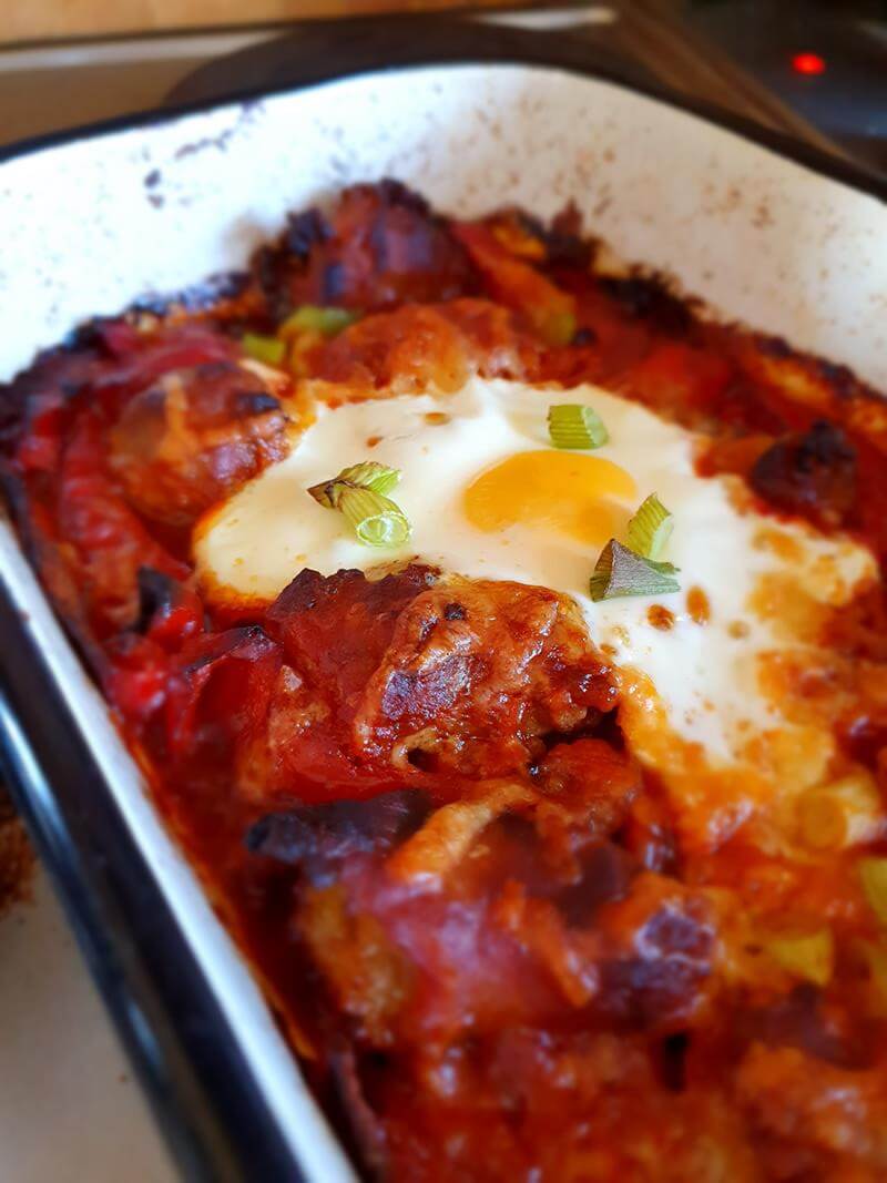 baked egg on sausage and tomato bake