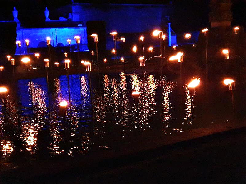 view of flickering burning lights on display in water