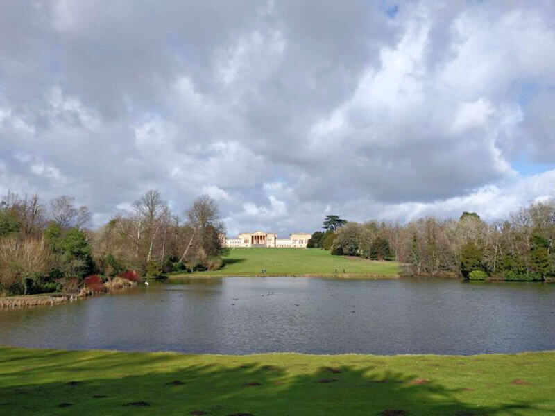 long shot view of Stowe house with lake in front