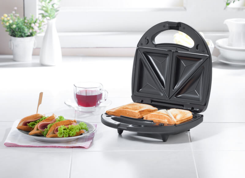 open toasted sandwich maker with plate and drink