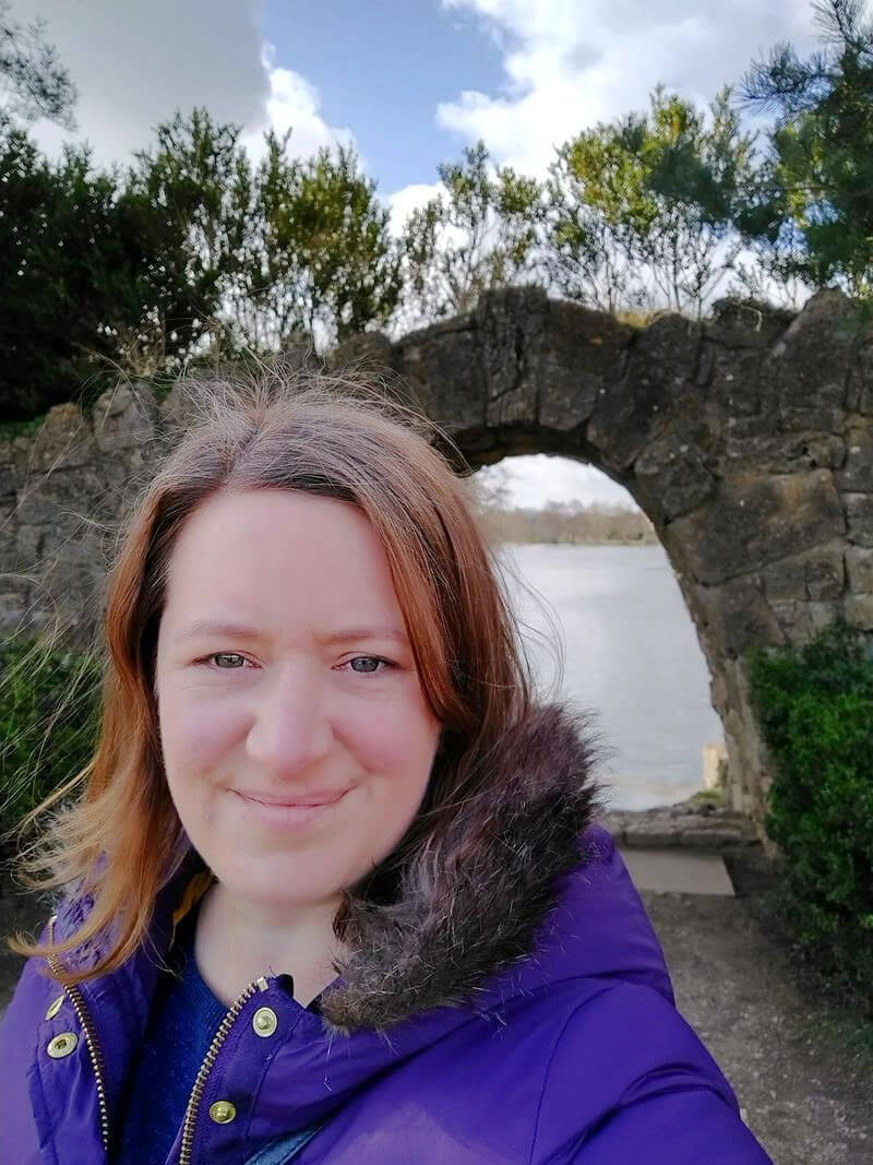 selfie of woman in front of archway lo