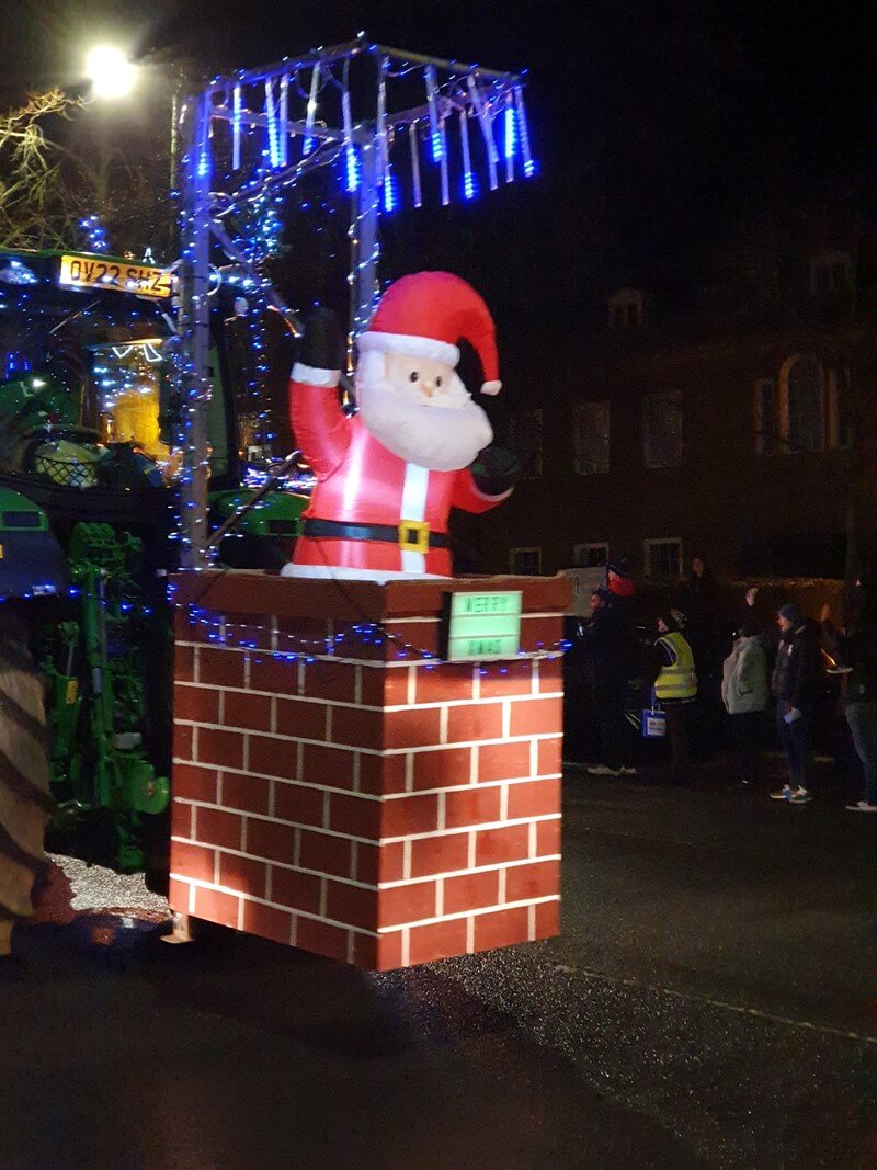 Santa and chimney on the back of a tractor