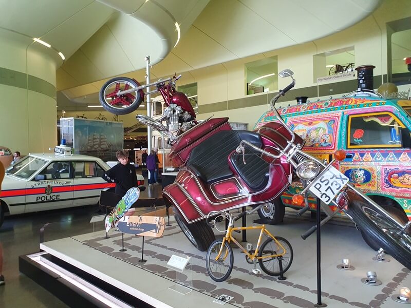 large motorbike trike on display with other vehicles
