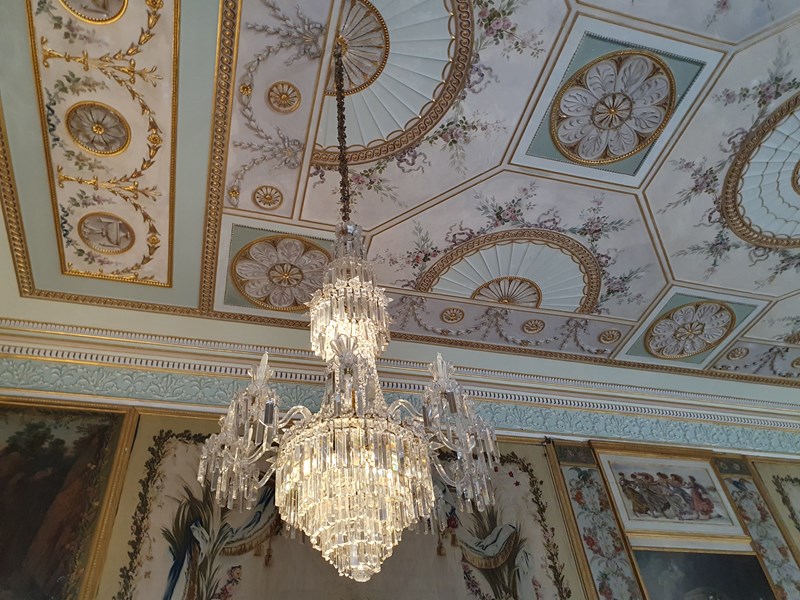 ornate glass chandelier with patterned designed ceiling