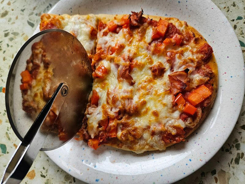 cutting an air fryer naan pizza