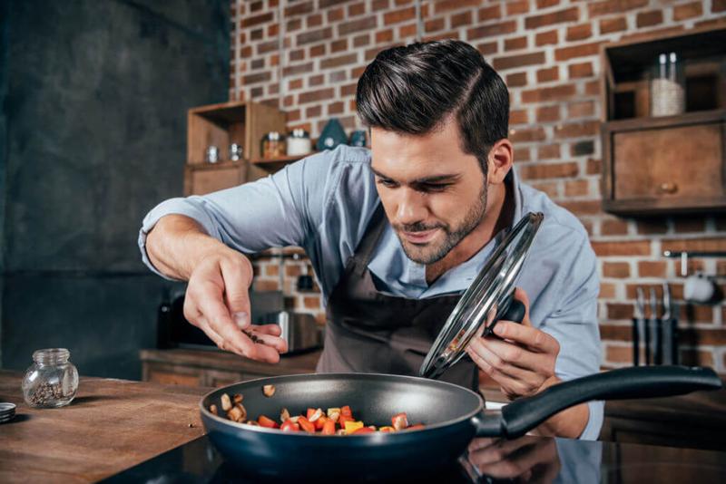 man cooking in a pan