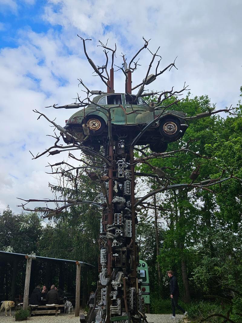 scrapyard car up a tree sculpture