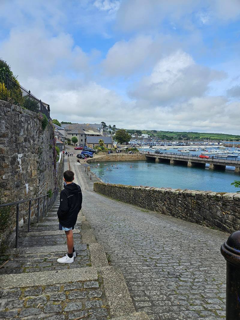joint path and road through Cornish streets with harbour area in Penzance
