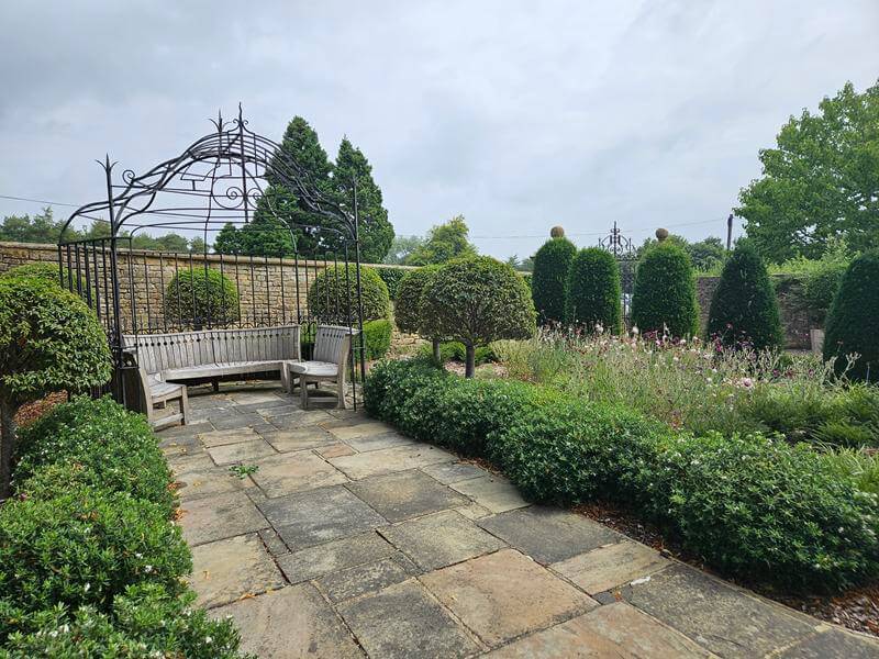 seating and borders at bourton house garden