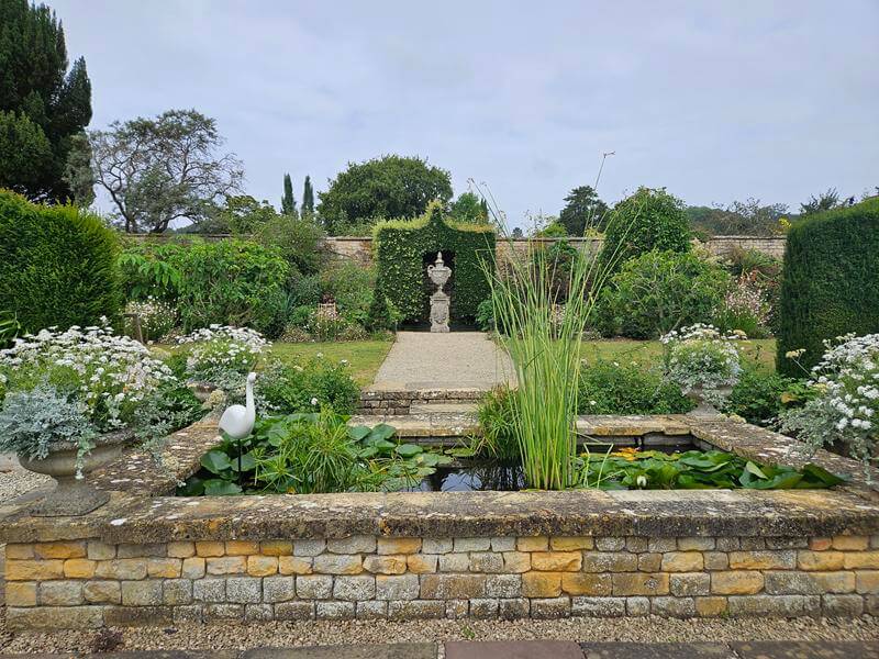 start of the white garden with fountain and pond